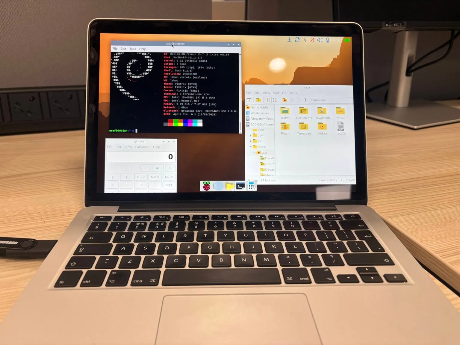 Raspberry Pi Desktop with the new 2026 icon dock running on a MacBook Pro over Debian 13 Trixie, showing fastfetch with the labwc Wayland compositor, the PCManFM file manager and Galculator